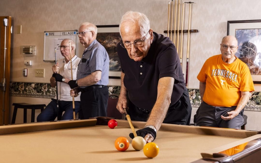 Residents enjoy a billiards game at Willow Brook Village in Delaware, Ohio, where game rooms and social spaces are part of the active senior lifestyle.